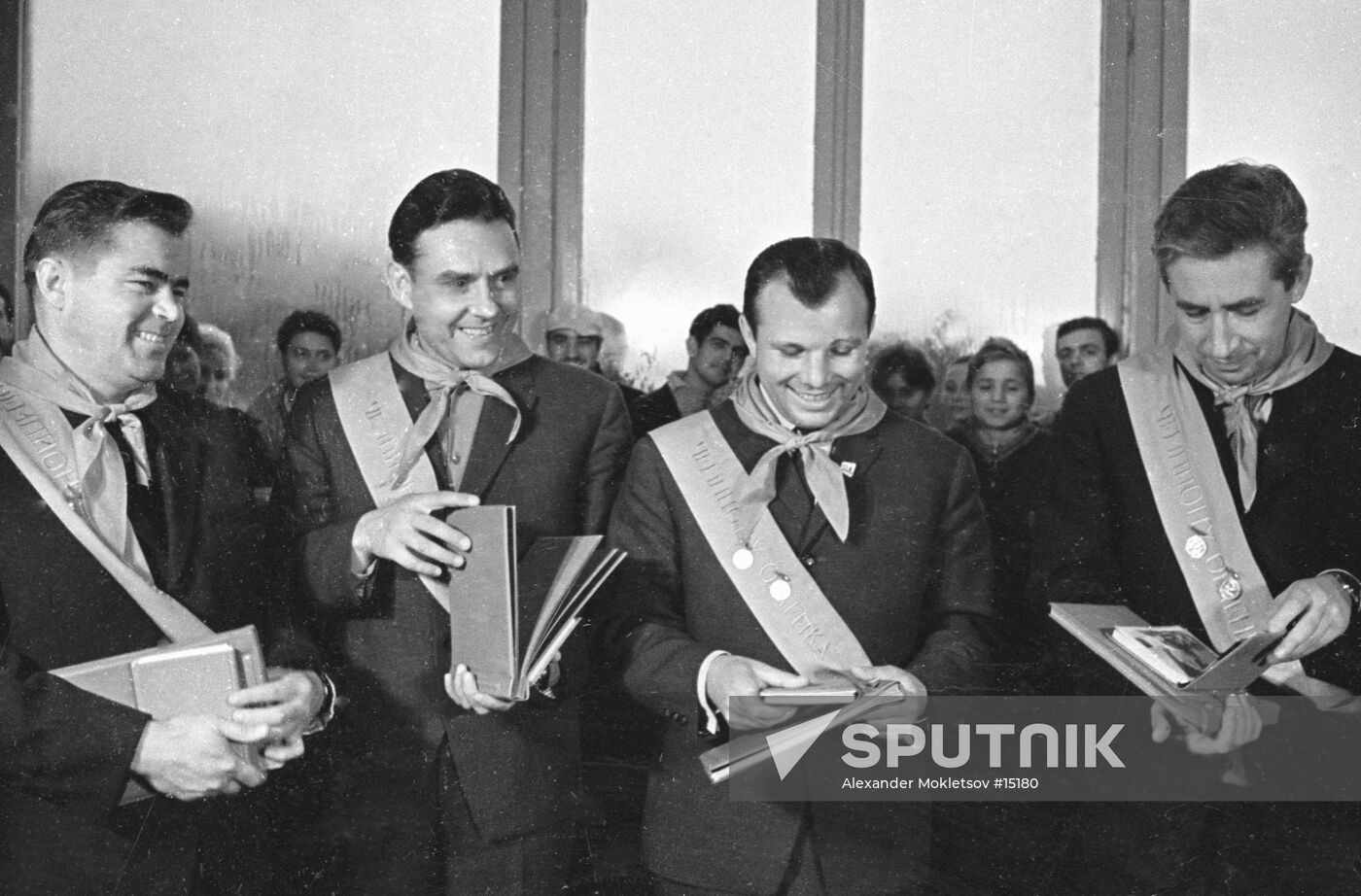 Andriyan Nikolayev, Vladimir Komarov, Yuri Gagarin and Konstantin Feoktistov receiving compliments from Young Pioneers
