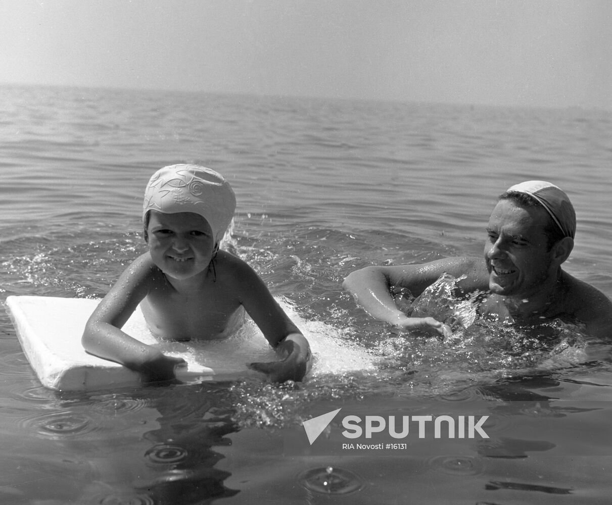 Komarov with his daughter bathing in the sea
