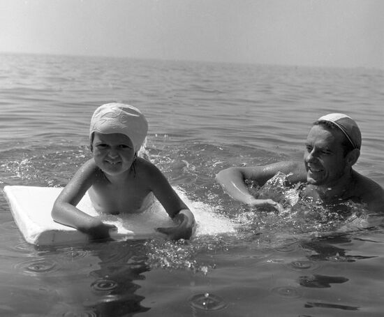 Komarov with his daughter bathing in the sea
