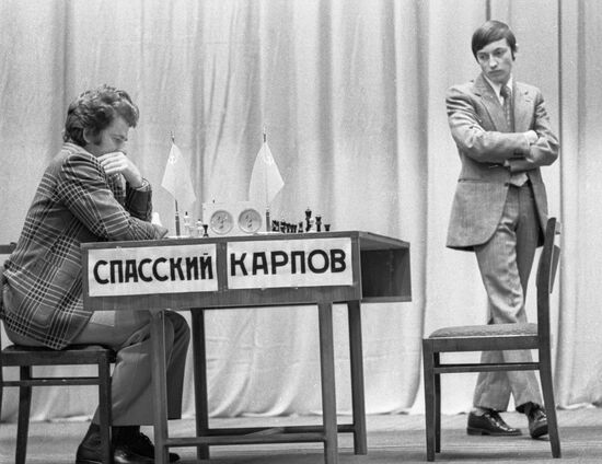 Russian chess grandmasters Boris Spassky, right, and Anatoly Karpov, left,  shake hands the news