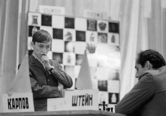 Russian chess grandmasters Boris Spassky, right, and Anatoly Karpov, left,  shake hands the news