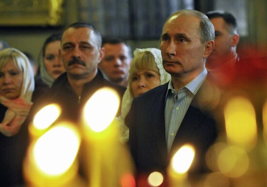 Vladimir Putin at Christmas service in St. Petersburg