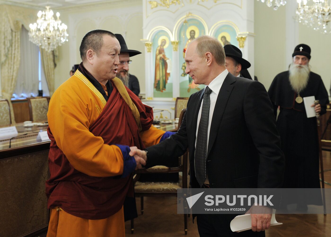 February 8, 2012. Prime Minister Vladimir Putin, right, meeting with representatives of the Russian Orthodox Church and other traditional faiths at the St. Daniel's Monastery as part of his presidential campaign. Left: Damba Ayushev, Pandito Khambo lama, Head of the Russian Buddhist traditional sangha. Location: Russia, Moscow. Author: Yana Lapikova/Sputnik. Vladimir Putin meets with representatives of traditional faiths