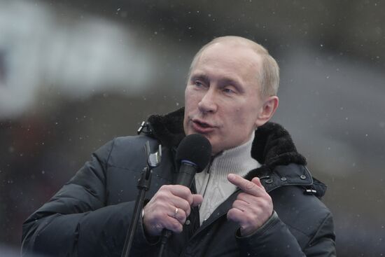 Vladimir Putin speaks to supporters at "Defend the Nation!"rally