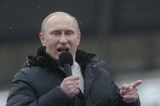 Vladimir Putin speaks to supporters at "Defend the Nation!"rally