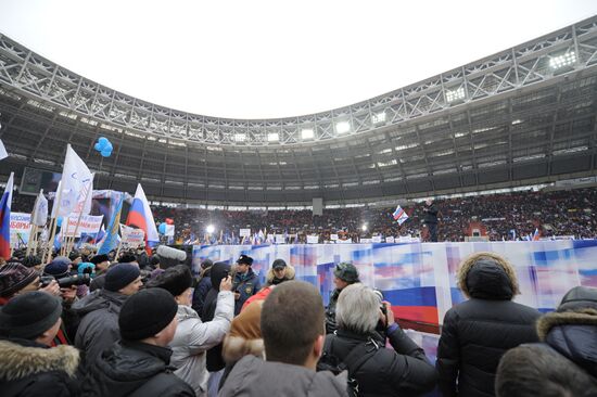 Vladimir Putin speaks to supporters at "Defend the Nation!"rally
