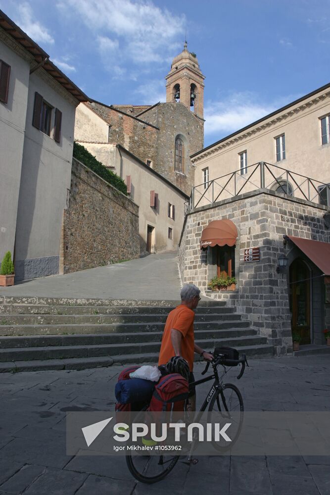 Tourist with bicycle in Montalcino