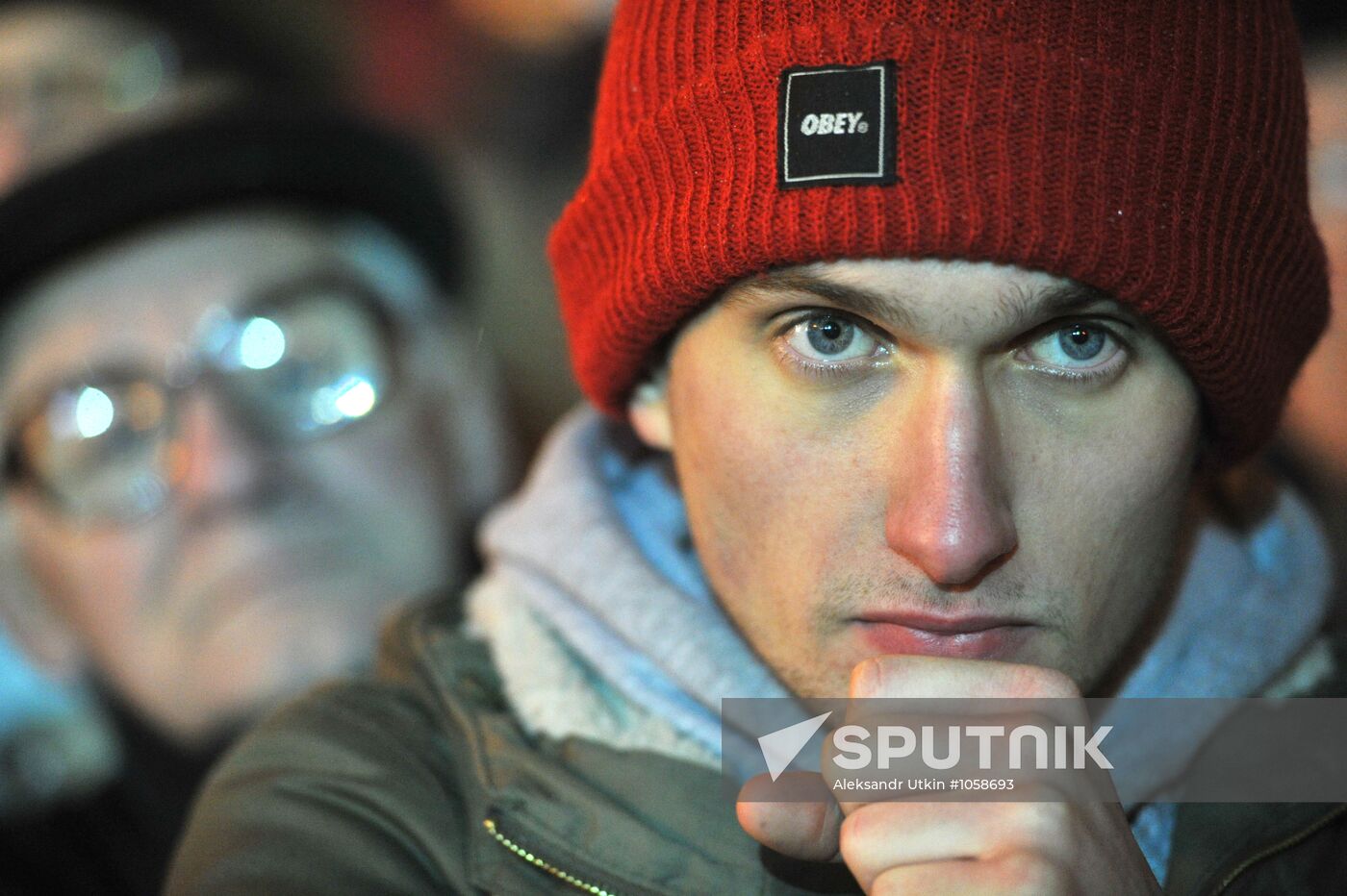 Faces of people rallying on Pushkin Square in Moscow