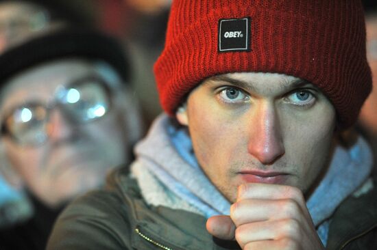 Faces of people rallying on Pushkin Square in Moscow