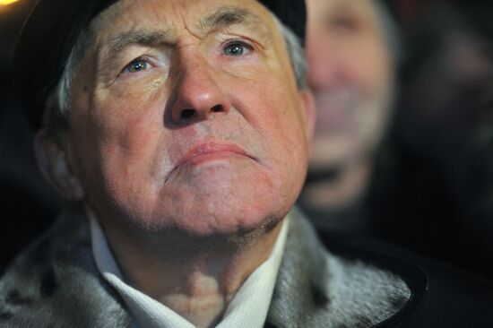 Faces of people rallying on Pushkin Square in Moscow