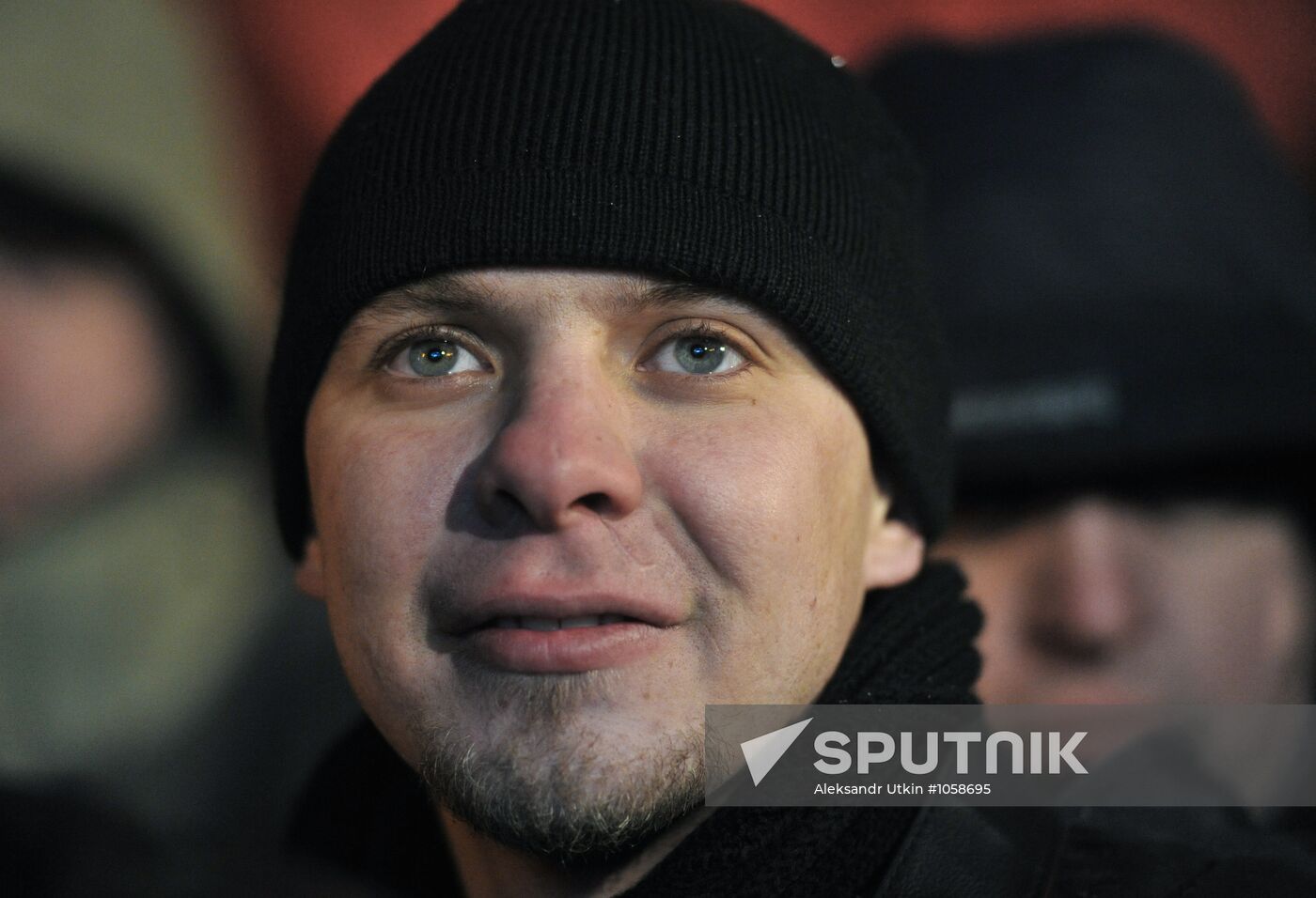 Faces of people rallying on Pushkin Square in Moscow