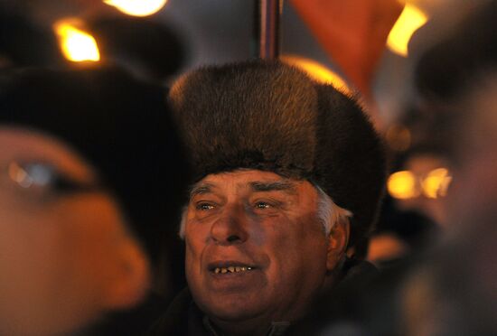Faces of people rallying on Pushkin Square in Moscow