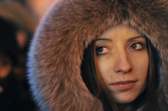 Faces of people rallying on Pushkin Square in Moscow