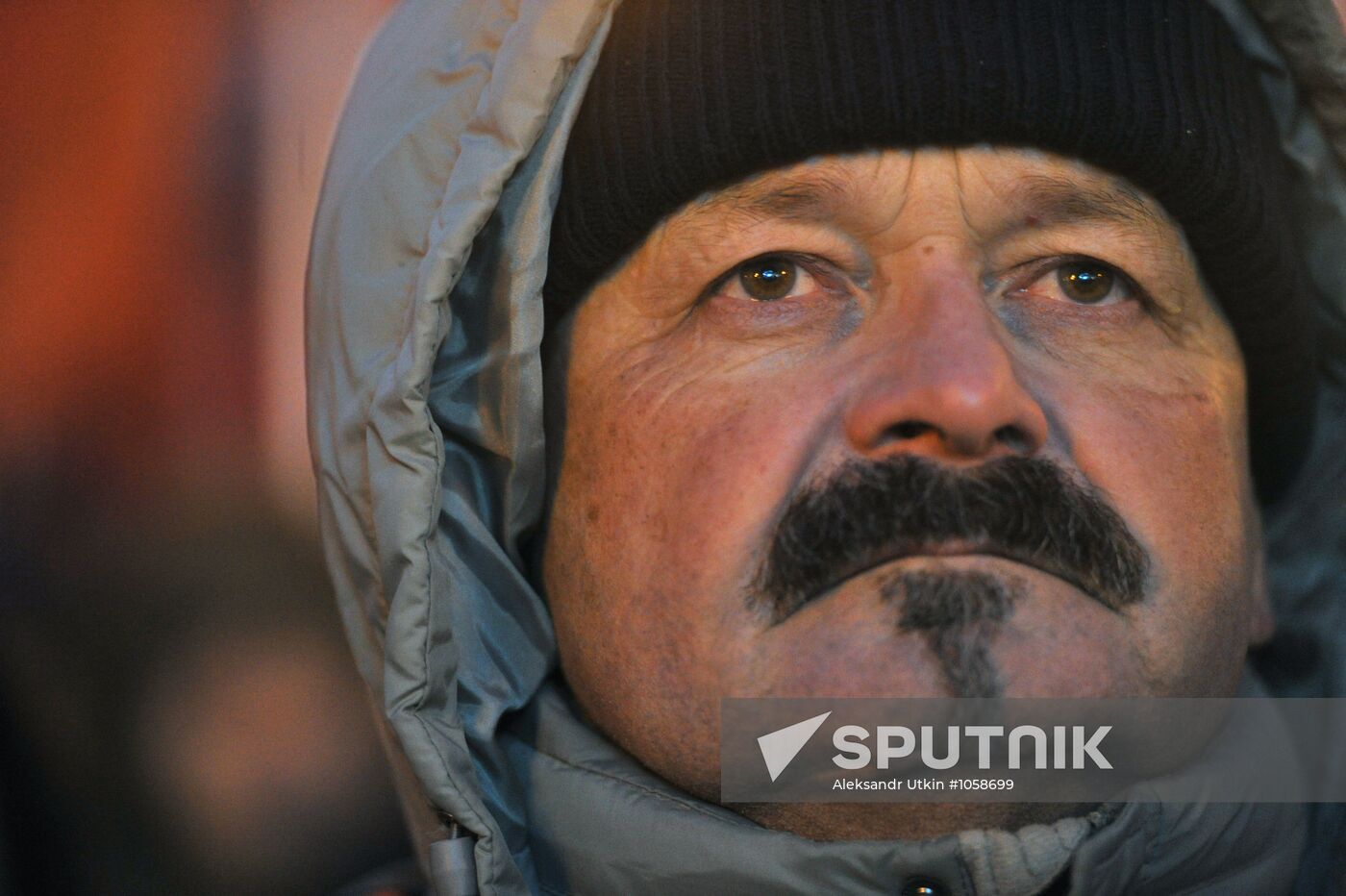 Faces of people rallying on Pushkin Square in Moscow
