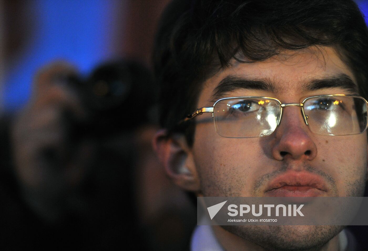 Faces of people rallying on Pushkin Square in Moscow