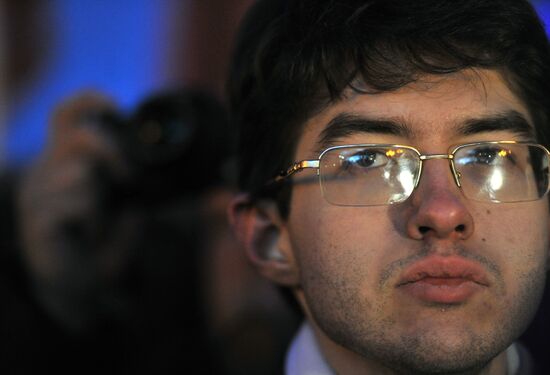 Faces of people rallying on Pushkin Square in Moscow