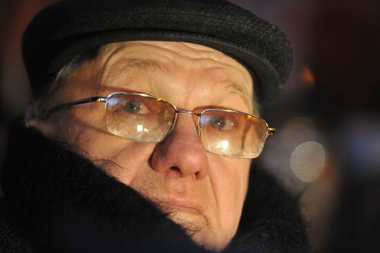 Faces of people rallying on Pushkin Square in Moscow