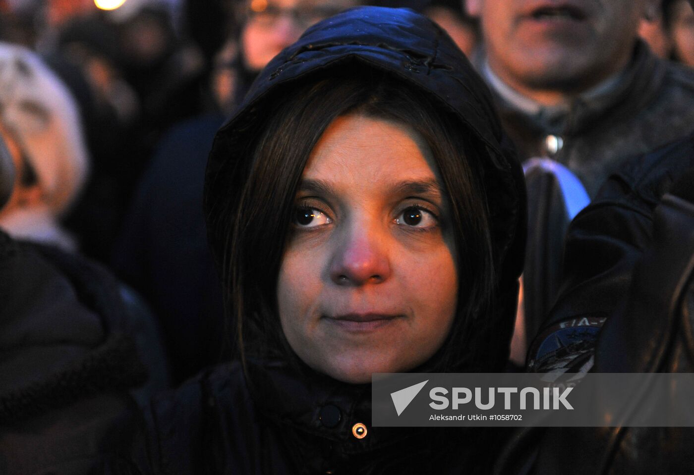 Faces of people rallying on Pushkin Square in Moscow