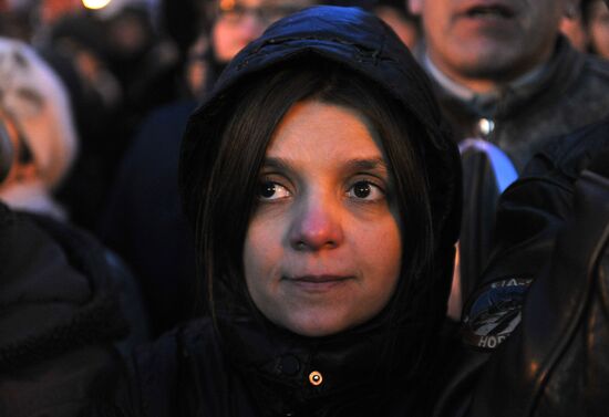 Faces of people rallying on Pushkin Square in Moscow