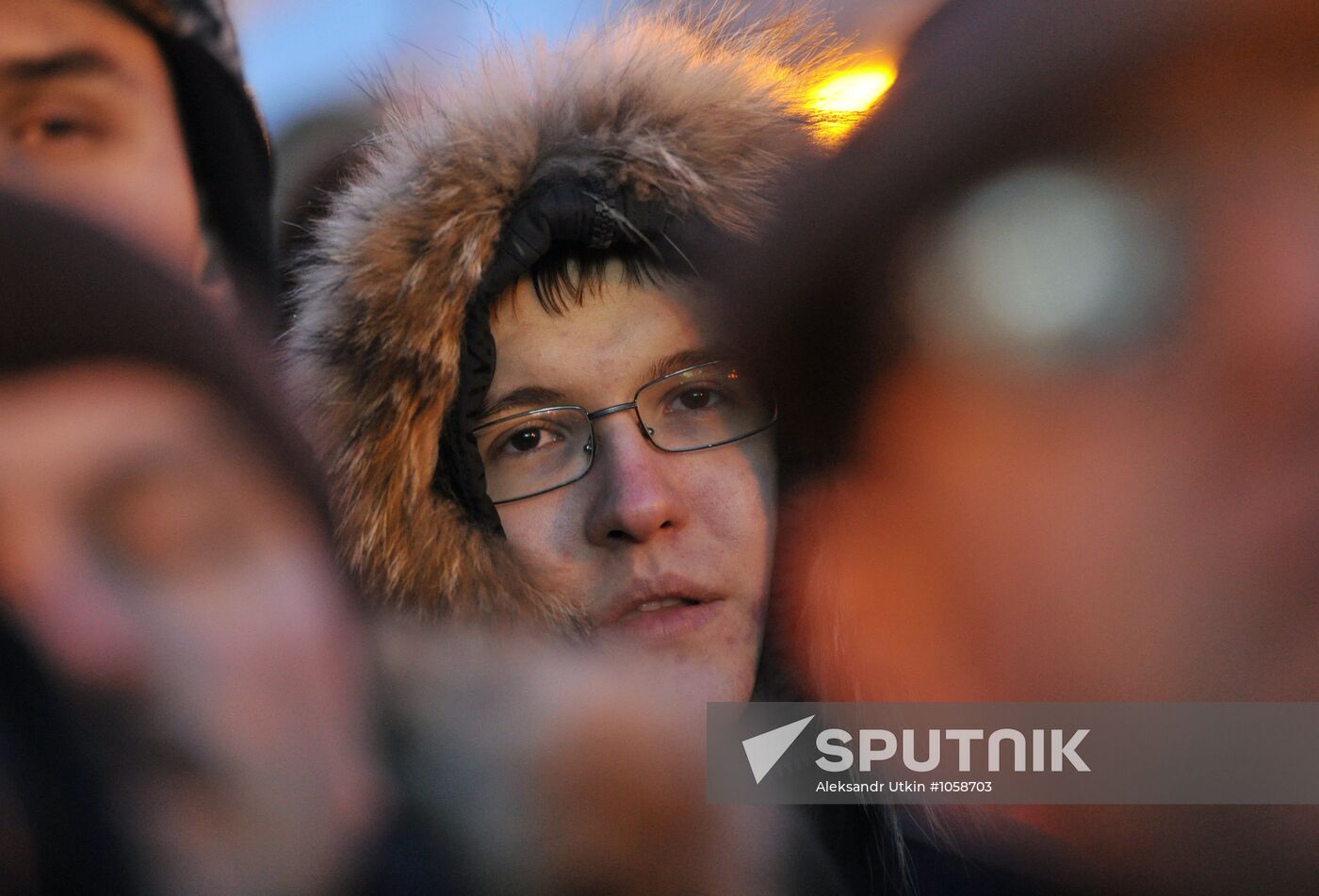 Faces of people rallying on Pushkin Square in Moscow