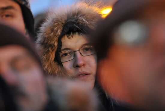 Faces of people rallying on Pushkin Square in Moscow