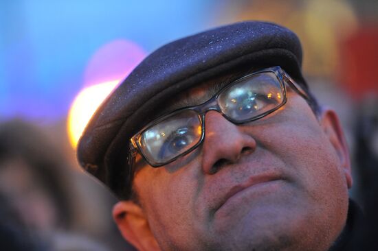 Faces of people rallying on Pushkin Square in Moscow