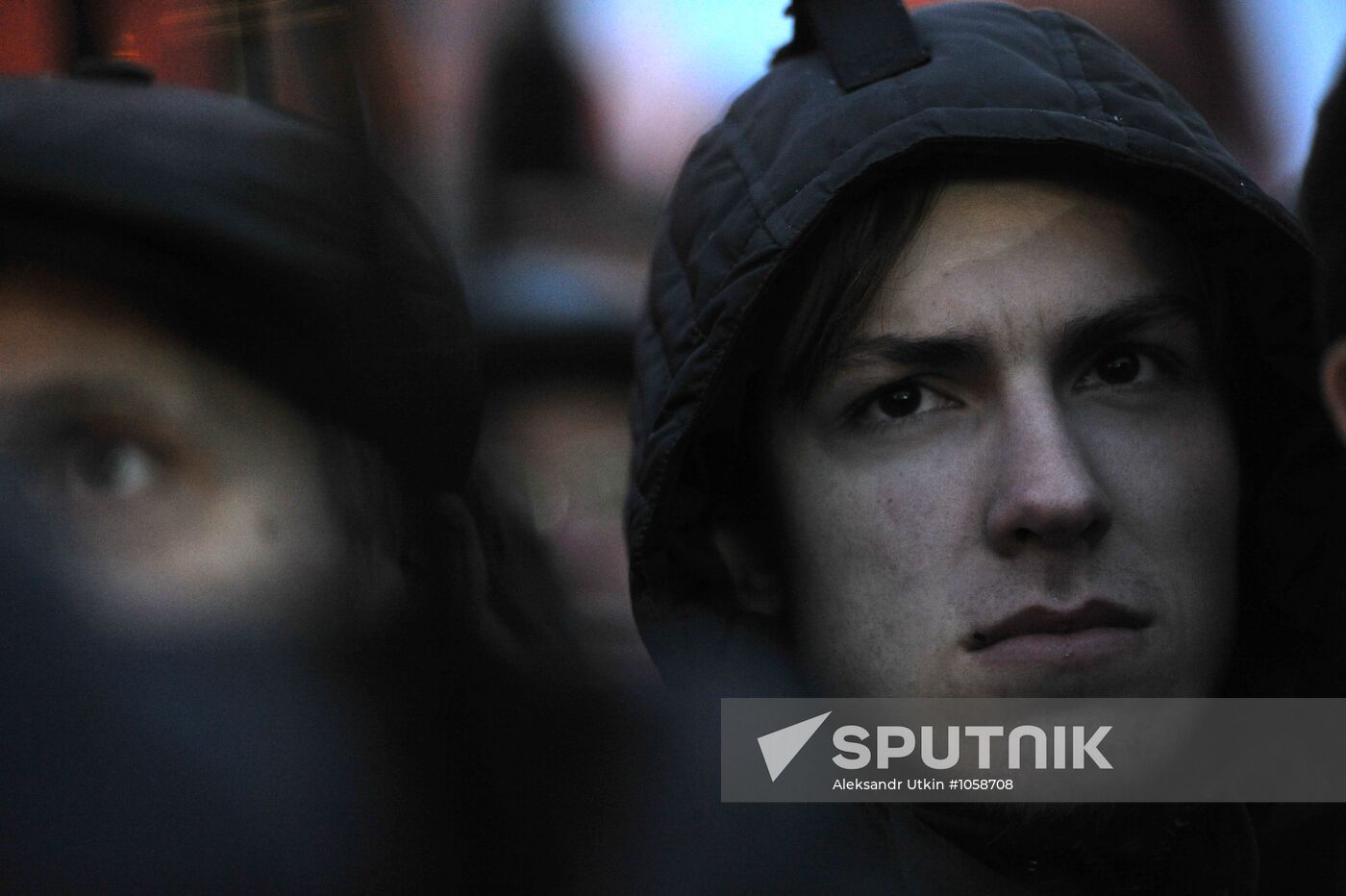 Faces of people rallying on Pushkin Square in Moscow
