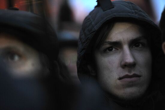 Faces of people rallying on Pushkin Square in Moscow