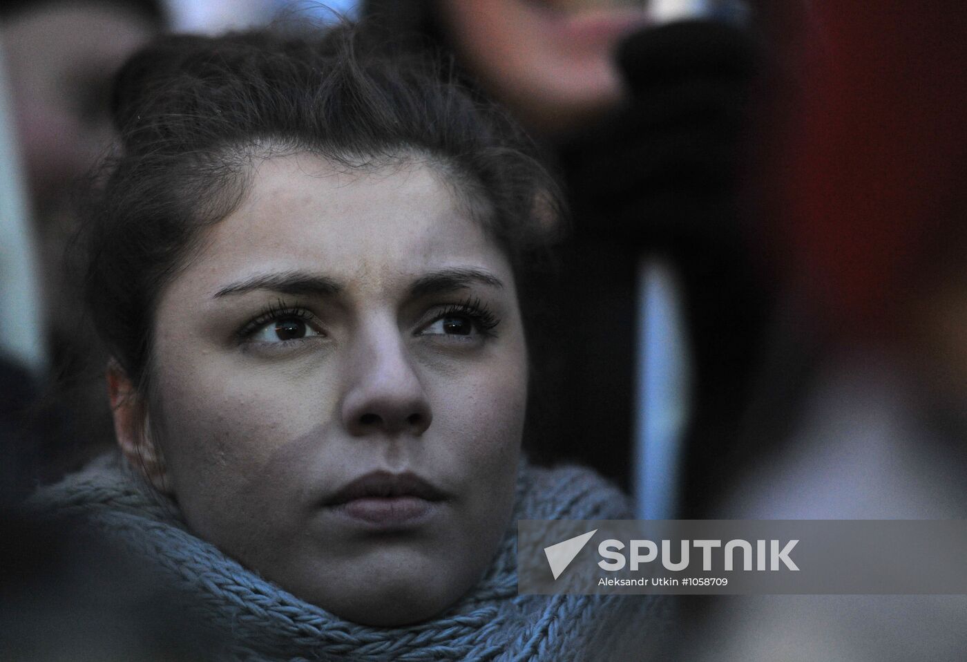 Faces of people rallying on Pushkin Square in Moscow