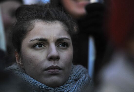 Faces of people rallying on Pushkin Square in Moscow