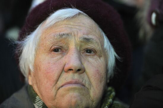 Faces of people rallying on Pushkin Square in Moscow