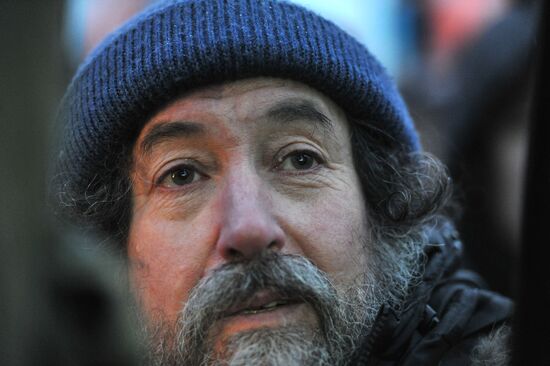 Faces of people rallying on Pushkin Square in Moscow