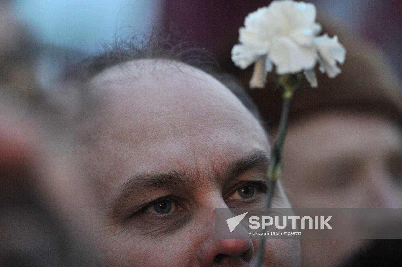 Faces of people rallying on Pushkin Square in Moscow