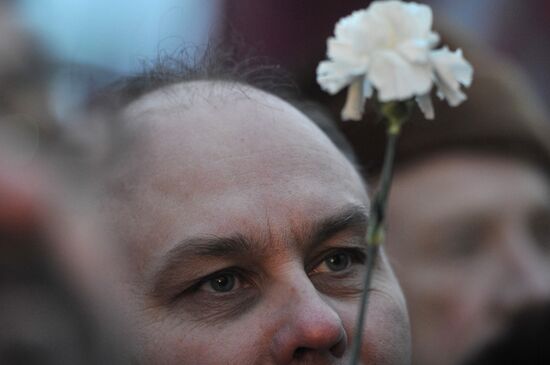 Faces of people rallying on Pushkin Square in Moscow