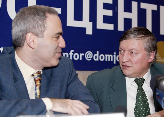 Russian chess grandmasters Boris Spassky, right, and Anatoly Karpov, left,  shake hands the news