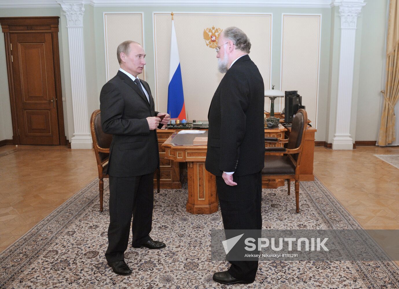 V. Churov presents V. Putin with presidential certificate