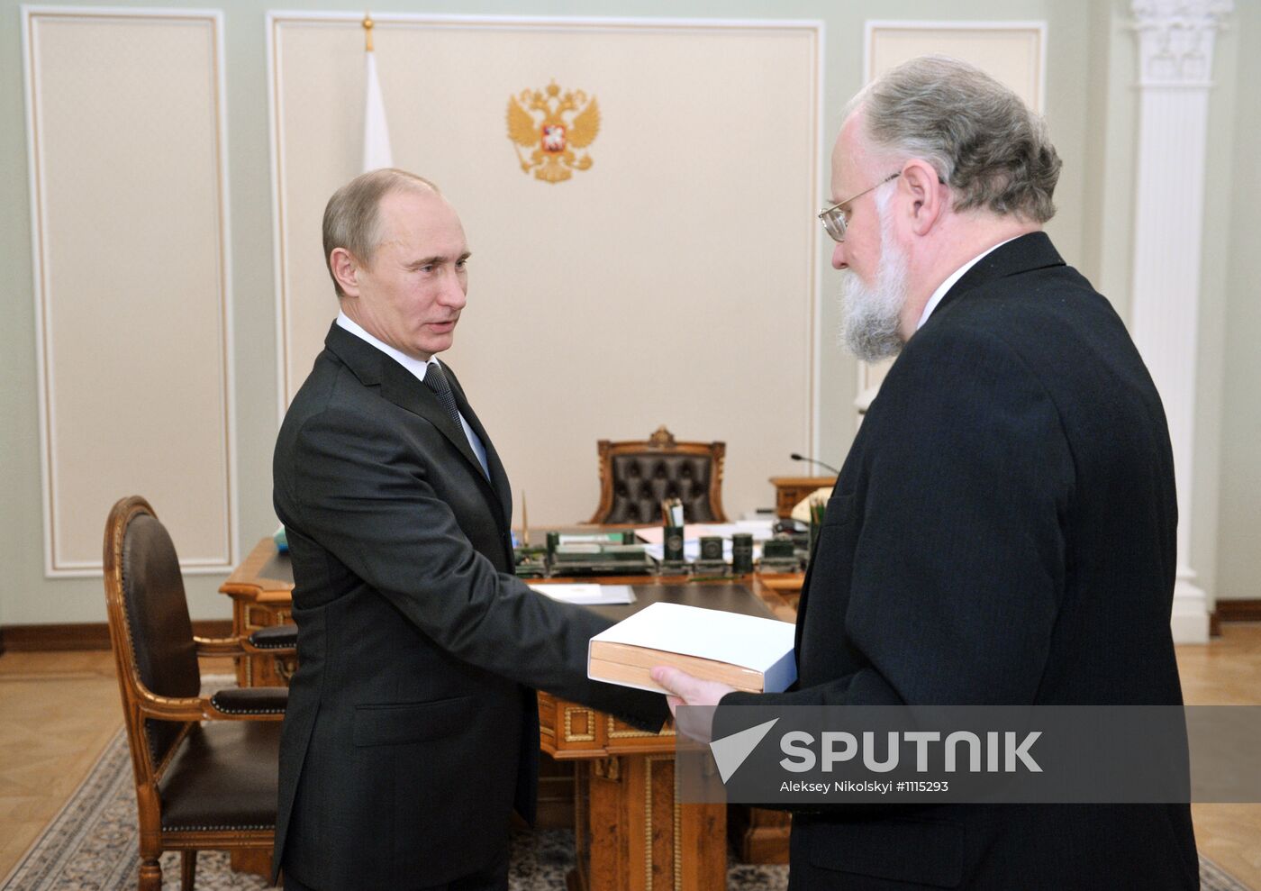 V. Churov presents V. Putin with presidential certificate