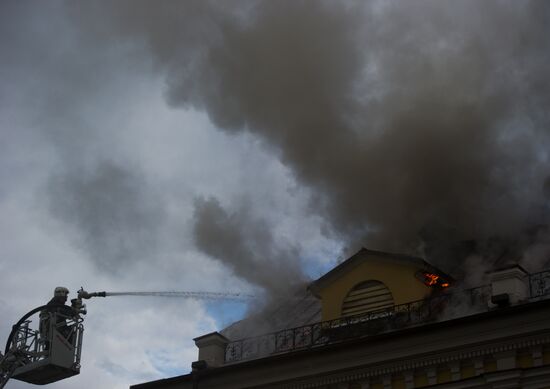 Old building on fire on Stoleshnikov Street in Moscow