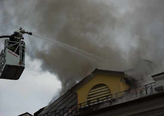 Old building on fire on Stoleshnikov Street in Moscow