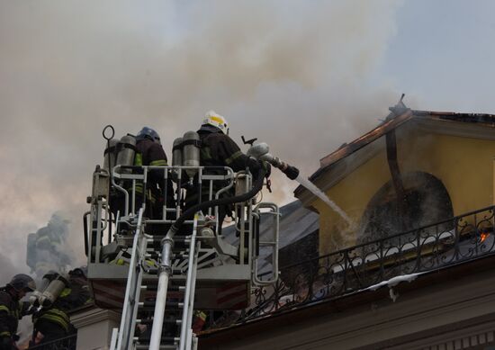 Old building on fire on Stoleshnikov Street in Moscow