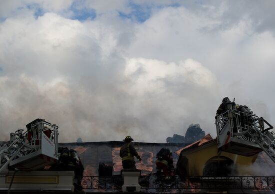 Old building on fire on Stoleshnikov Street in Moscow