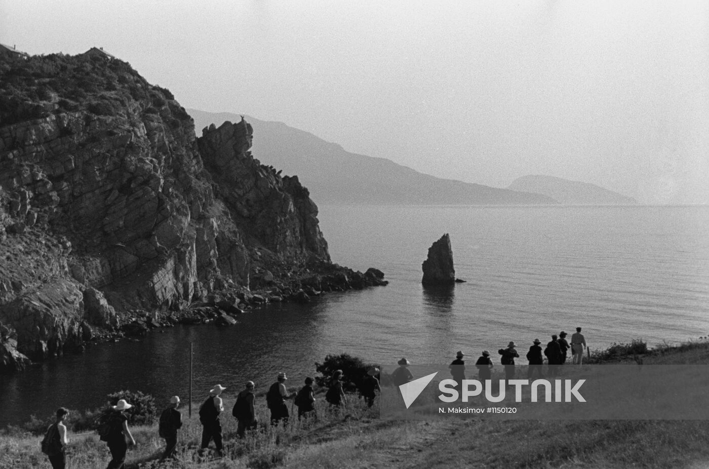 Tourists on coast of Black Sea in Crimea