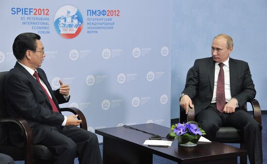 Vladimir Putin meets with He Guo-qiang in St.Petersburg