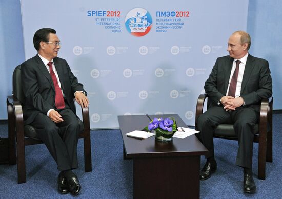 Vladimir Putin meets with He Guo-qiang in St.Petersburg