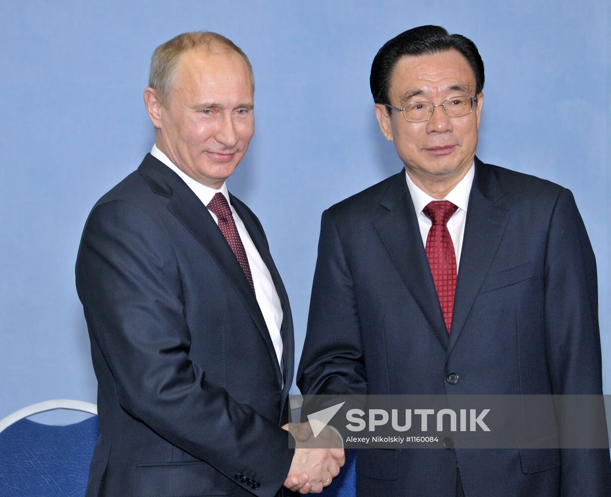 Vladimir Putin meets with He Guo-qiang in St.Petersburg