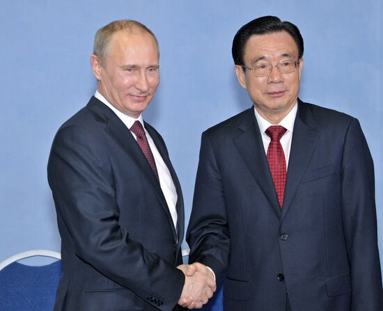 Vladimir Putin meets with He Guo-qiang in St.Petersburg