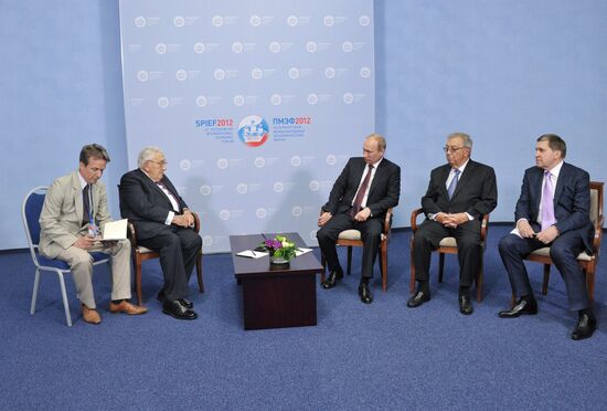 Vladimir Putin meets with Henry Kissinger in St Petersburg