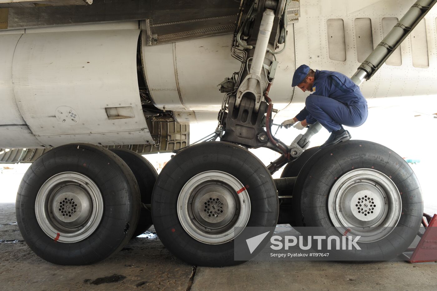 Technician maintains landing gear of Tu-160 strategic bomber