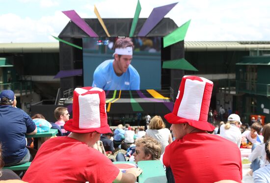 Viewers watch tennis match's broadcast at Wimbledon Stadium