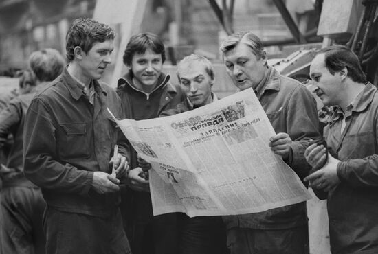 Workers with newspaper